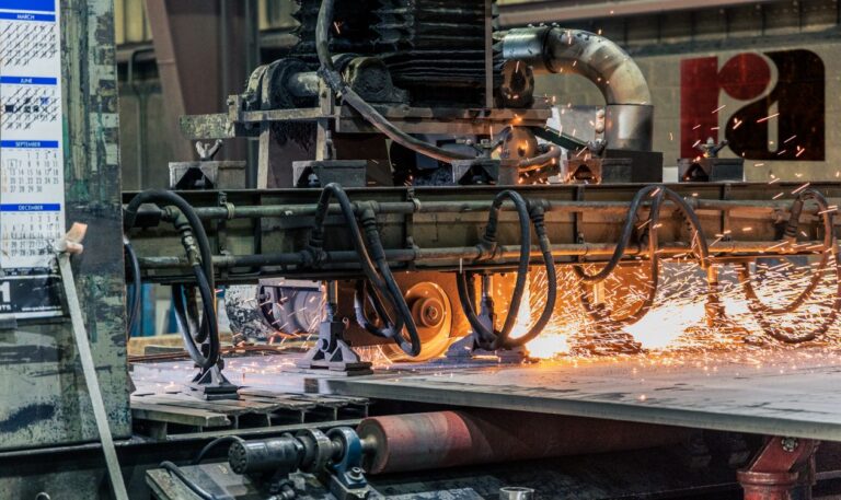 Industrial metal-cutting machinery at work in a manufacturing facility.