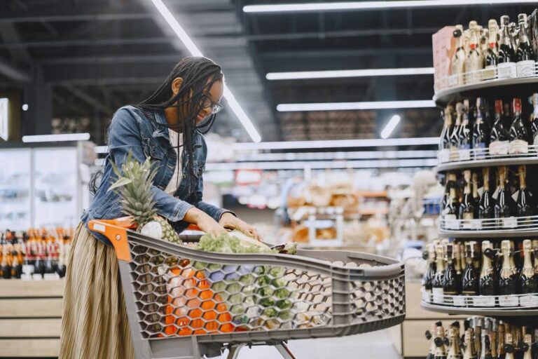 Shopper selects groceries in a supermarket as consumer spending rises