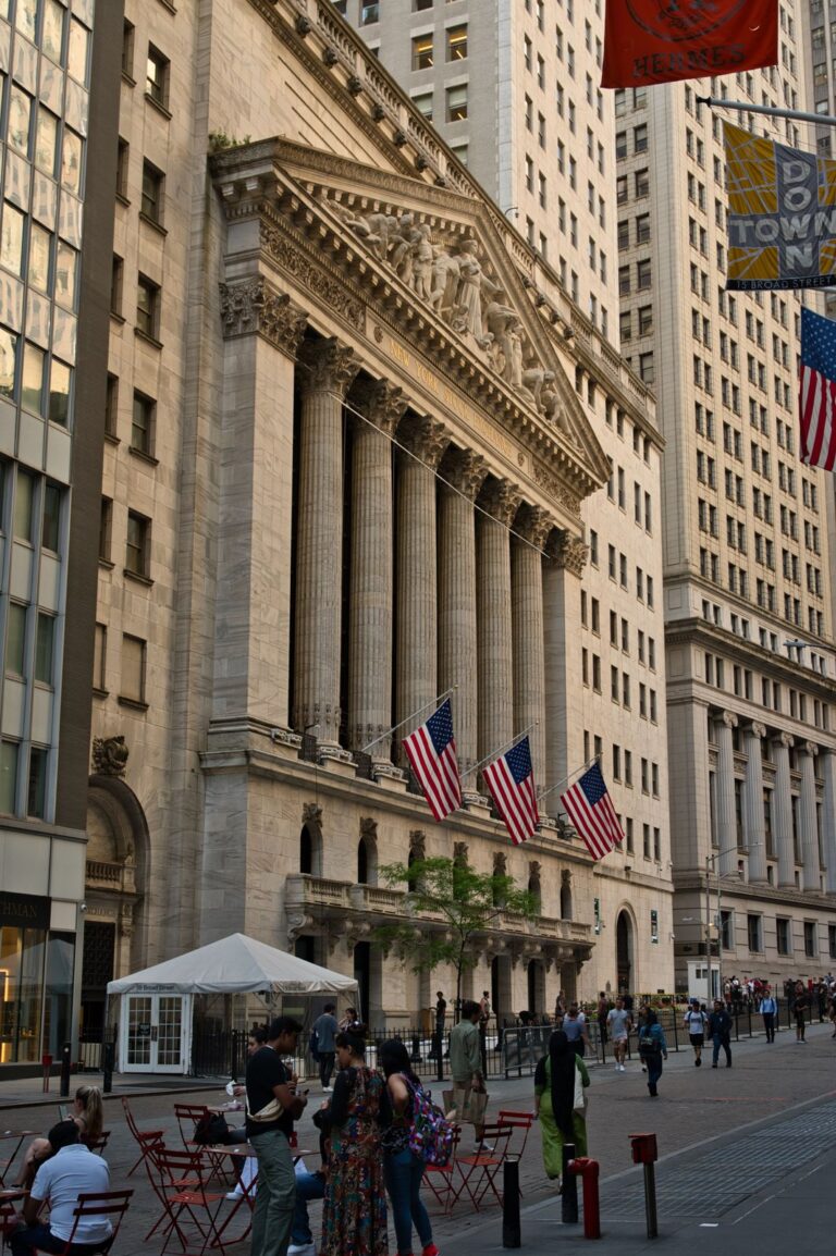 New York Stock Exchange columns and American flags on Broad Street