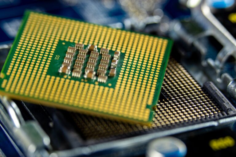 Close-up of a computer processor resting above its socket on a motherboard