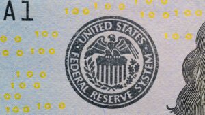 Close-up of the Federal Reserve System seal printed on a US hundred-dollar bill
