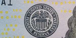 Close-up of the Federal Reserve System seal printed on a US banknote