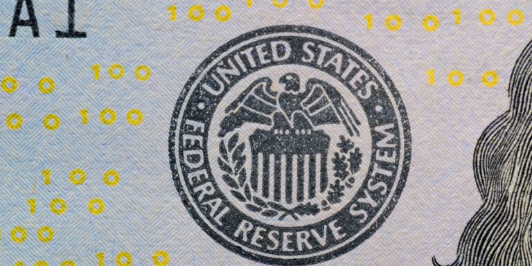 Close-up of the Federal Reserve System seal printed on a US banknote